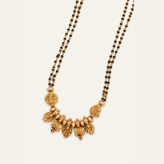 Close-up of Lakshmi temple mangalsutra with double strand black bead chain and antique gold plated Goddess Lakshmi beads – Jija Jewellery