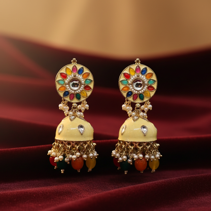 Pair of multi colour meena work zumka earrings on maroon velvet