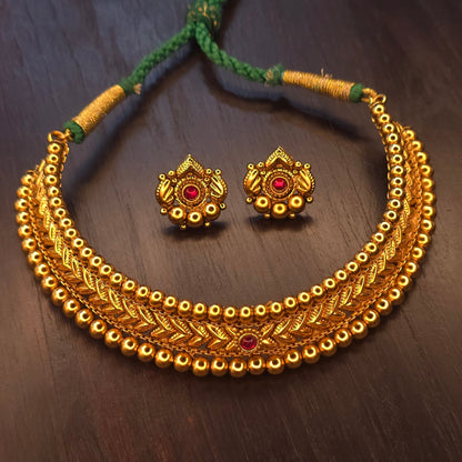 Thushi-inspired antique gold choker with engraved leaf-motif band and double gold bead border on green braided dori