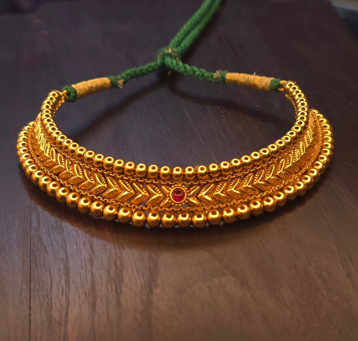 Hirkani Thushi choker necklace set in antique gold plating with green dori, ruby-red centre stone and lotus stud earrings – Jija Jewellery